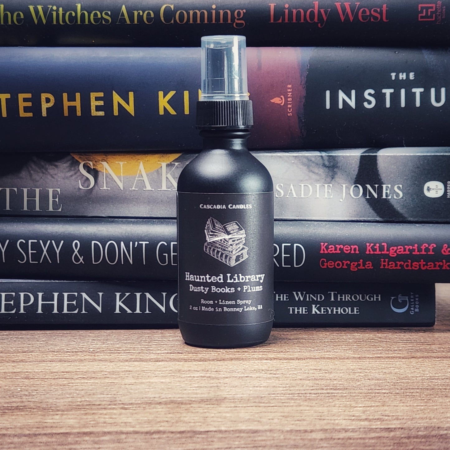 Haunted Library room and linen spray in front of stack of books