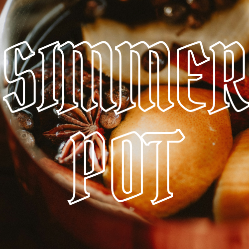 A close-up of a rustic ceramic pot filled with warm spices and citrus slices, overlaid with the text 'SIMMER POT' in a white outlined font.