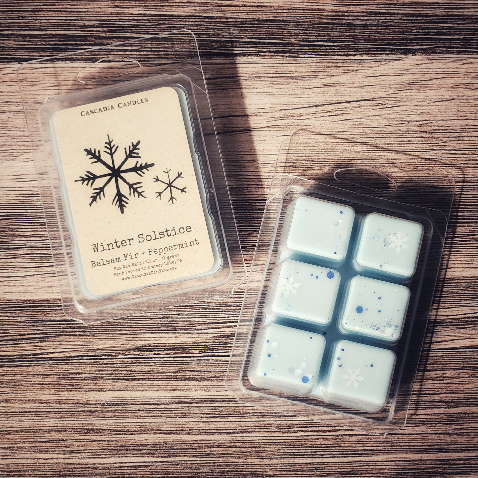 Packaged wax melts with a label on a wooden surface