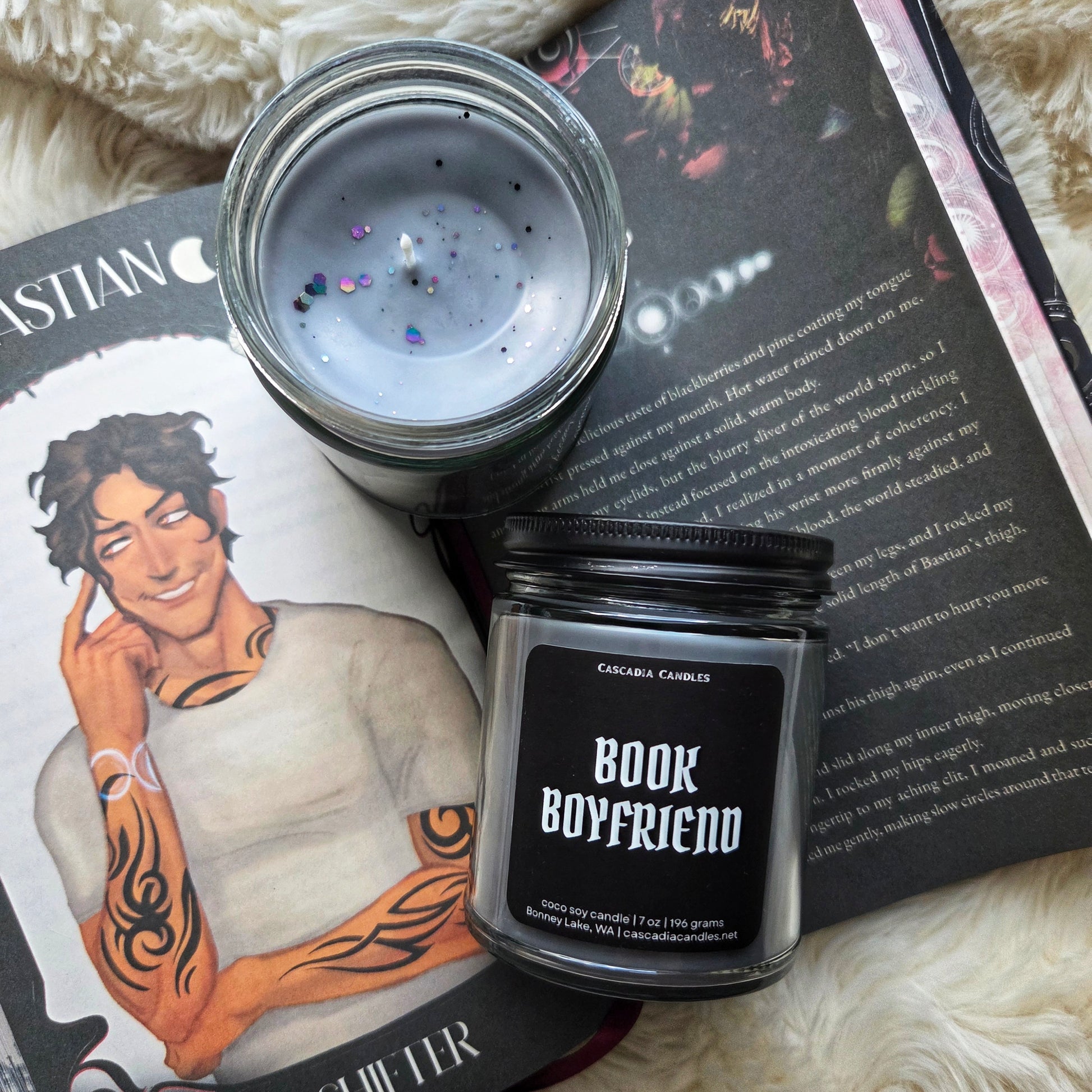 Candle labeled 'Book Boyfriend' with a book and illustration of a man on a surface