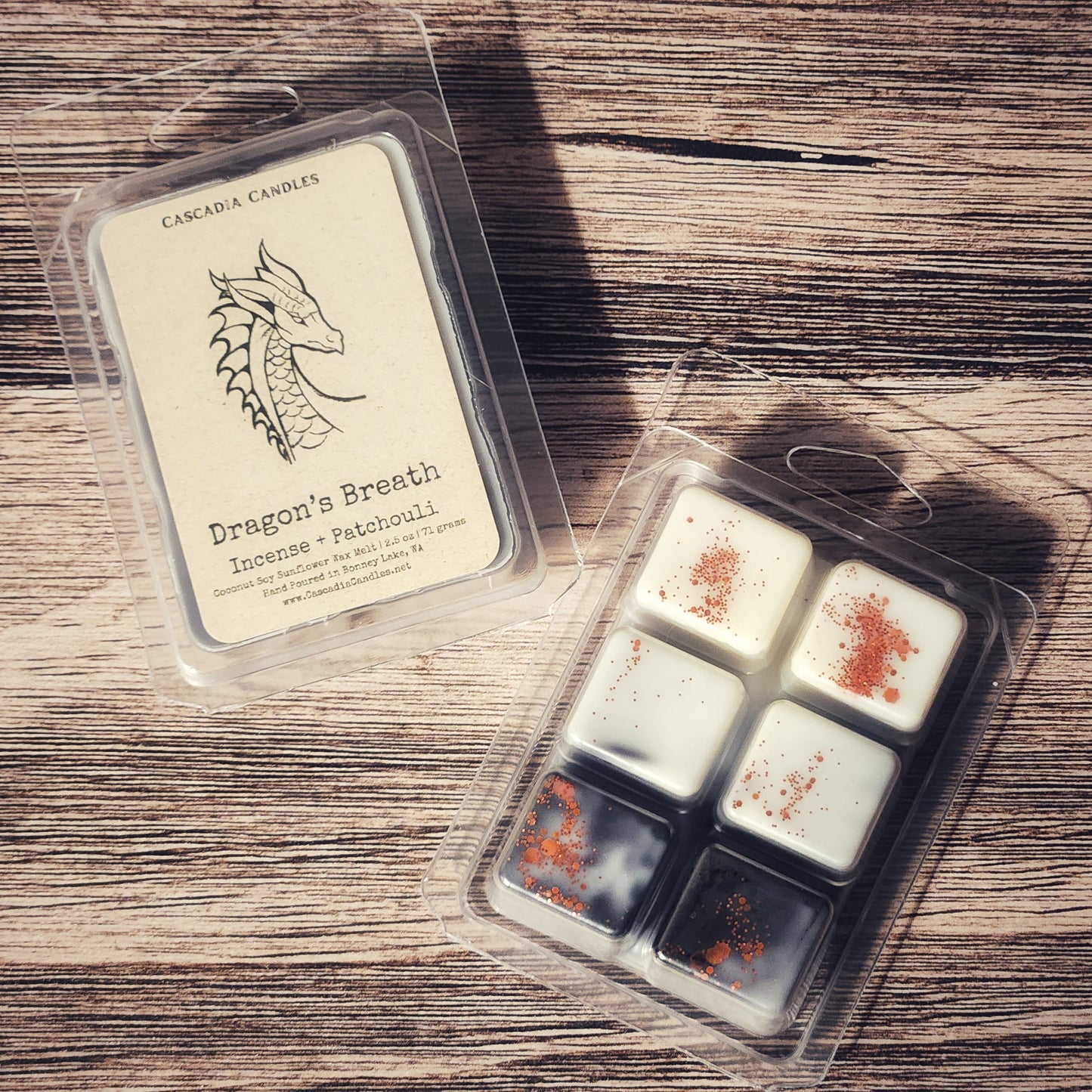 Packaged wax melts with 'Dragon's Breath' label on a wooden surface