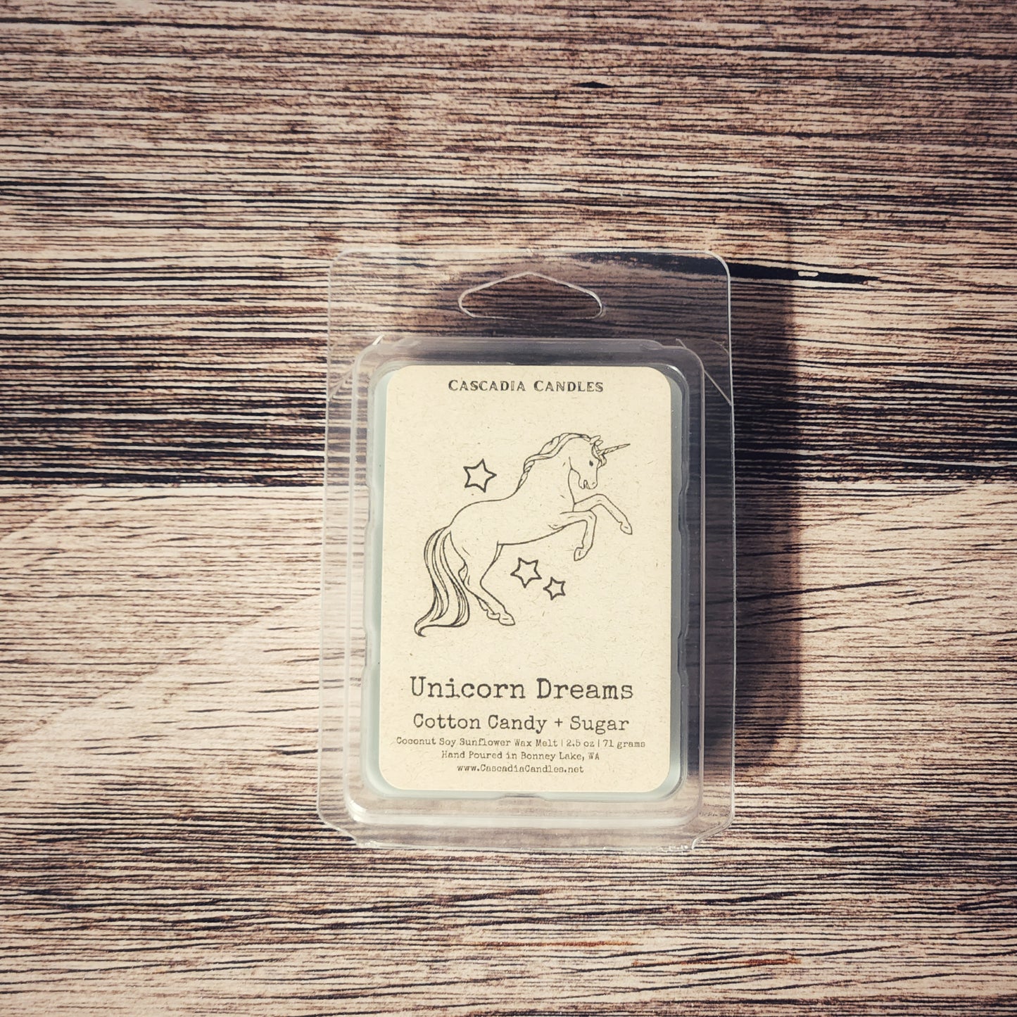 Cascadia Candles Unicorn Dreams wax melt packaging on a wooden surface