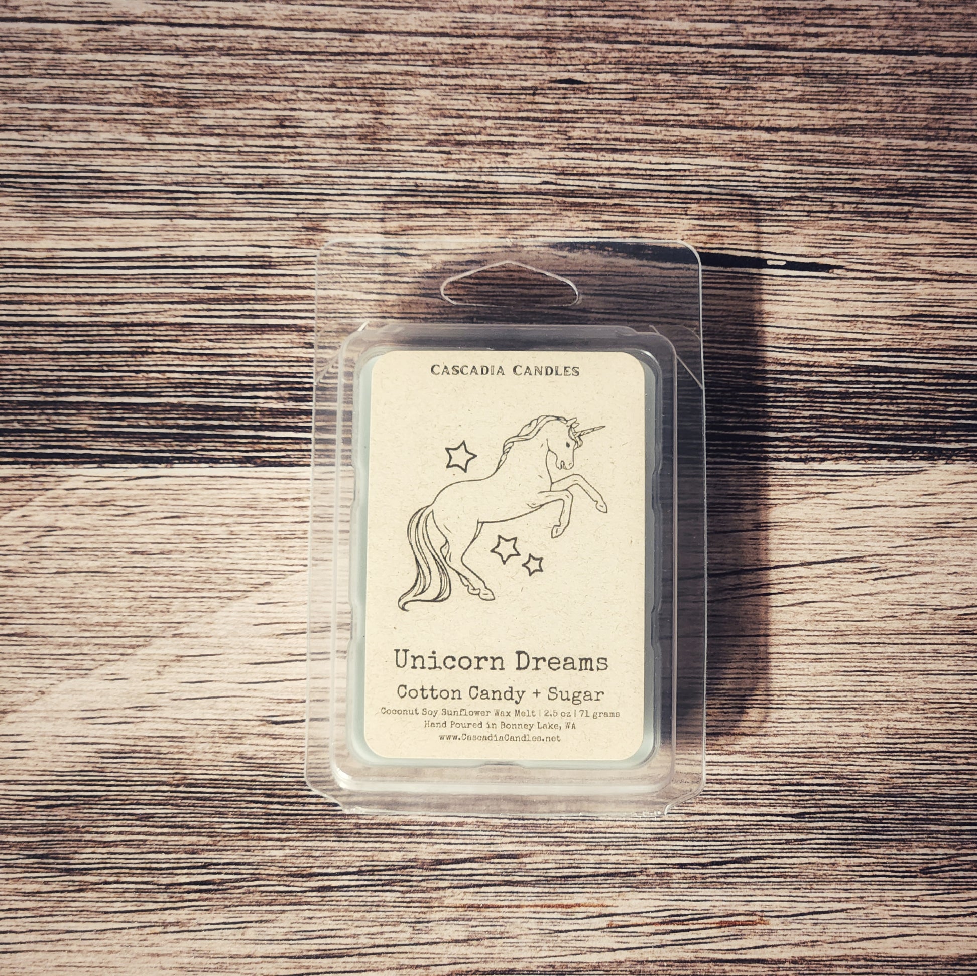 Cascadia Candles Unicorn Dreams wax melt packaging on a wooden surface