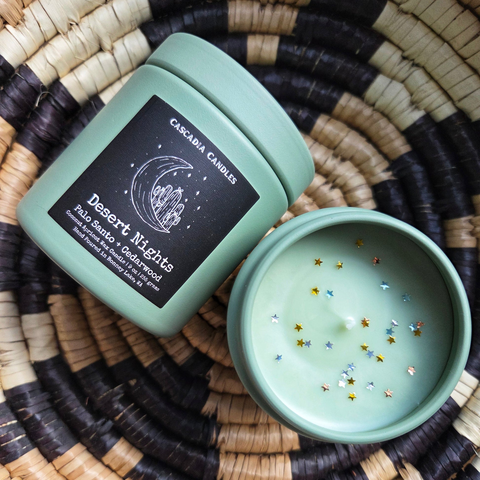 Mint green candle with 'Desert Nights' label on a woven surface