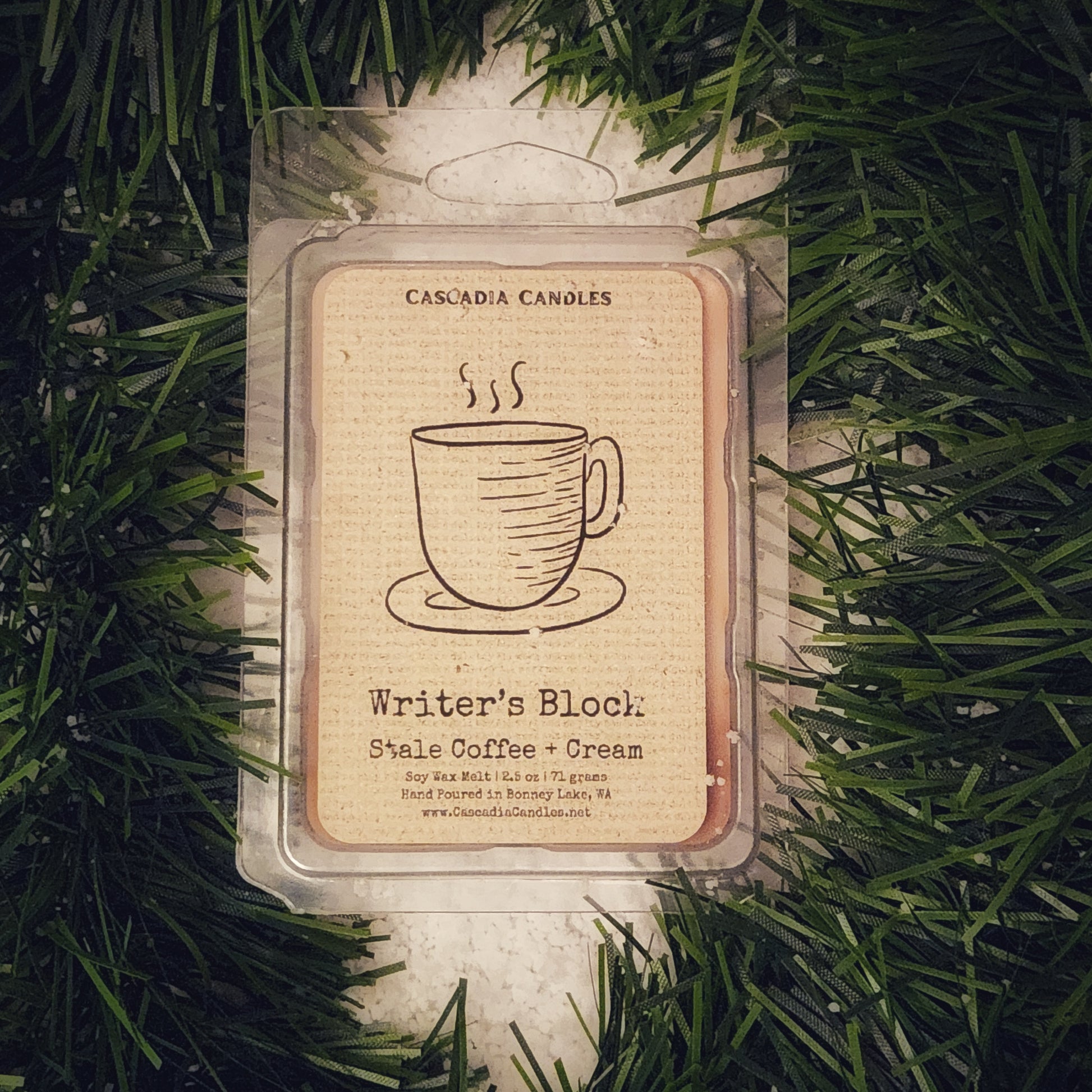 Wax melt packaging with a coffee cup design on a green garland and snow background