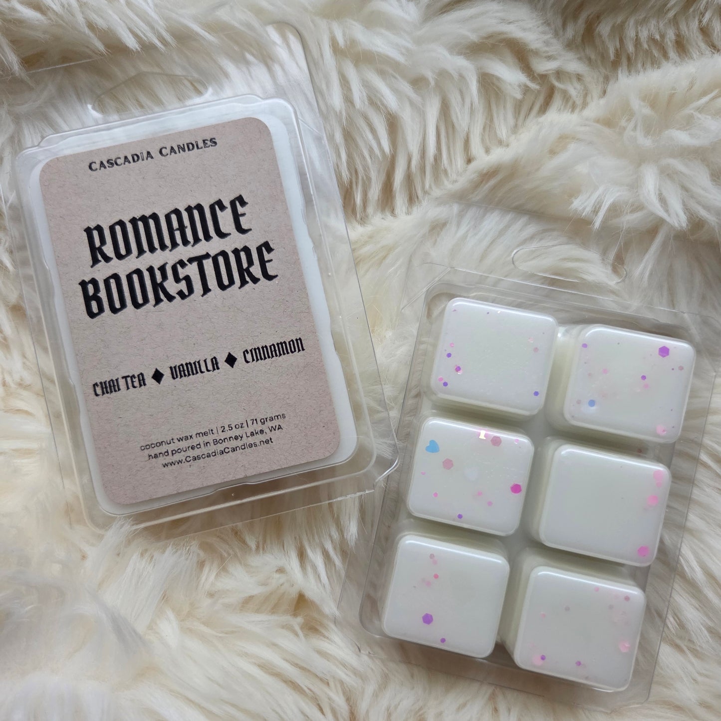 Wax melts in packaging labeled 'Romance Bookstore' on a fluffy white surface