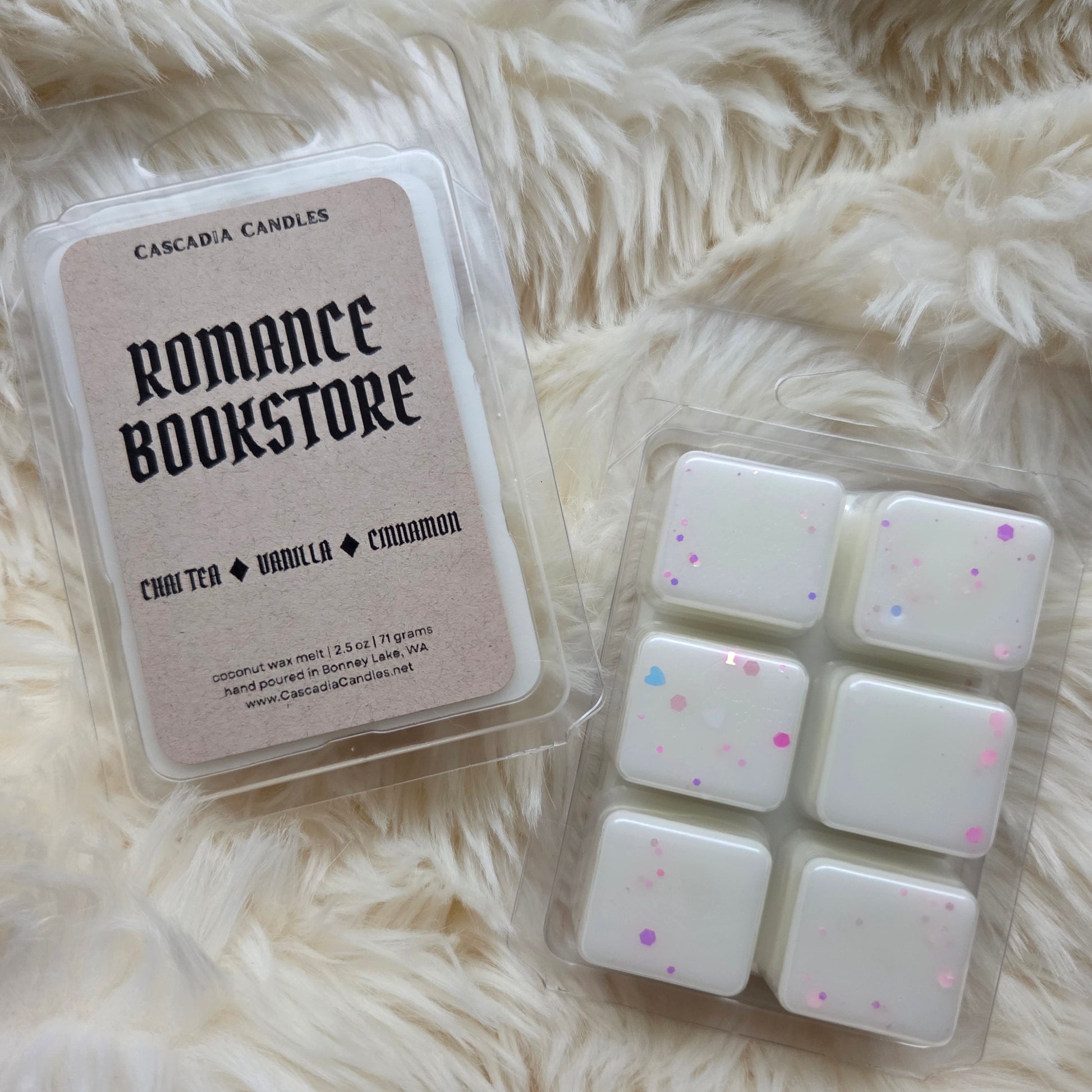 Wax melts in packaging labeled 'Romance Bookstore' on a fluffy white surface