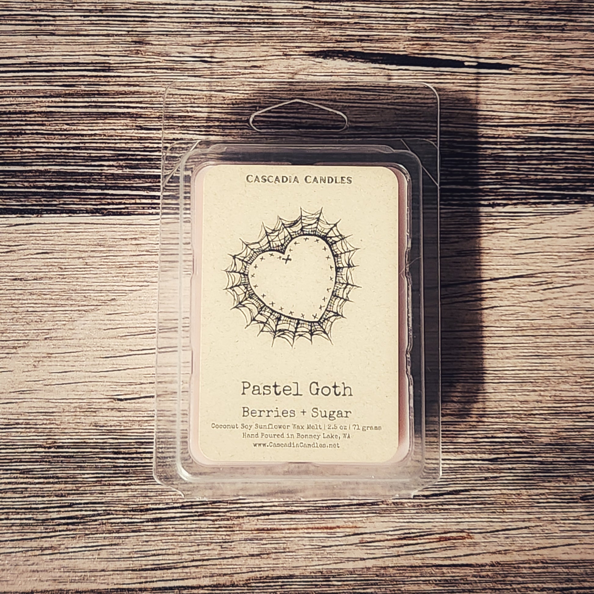Cascadia Candles Pastel Goth Berries & Sugar wax melt package on a wooden surface