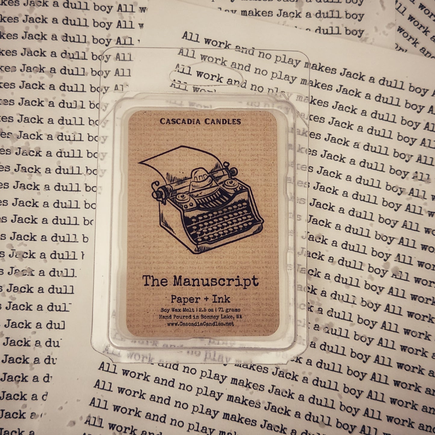 The Manuscript wax melt with typewriter illustration on a background of text.