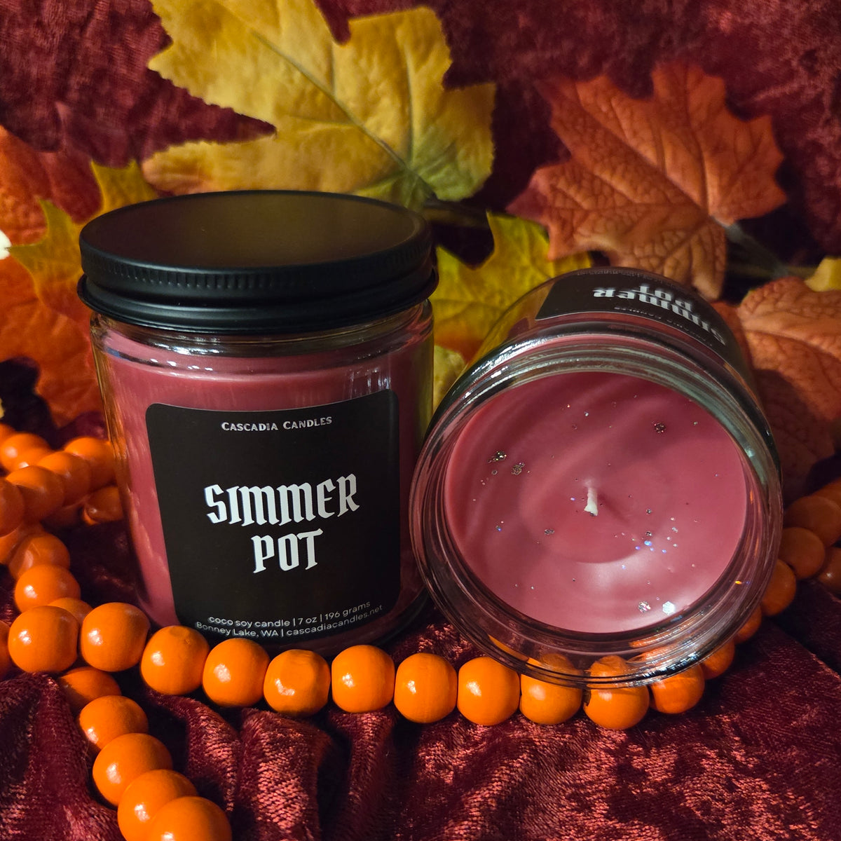Two Simmer Pot candles side-by-side showing the label and top of candle simultaneously.