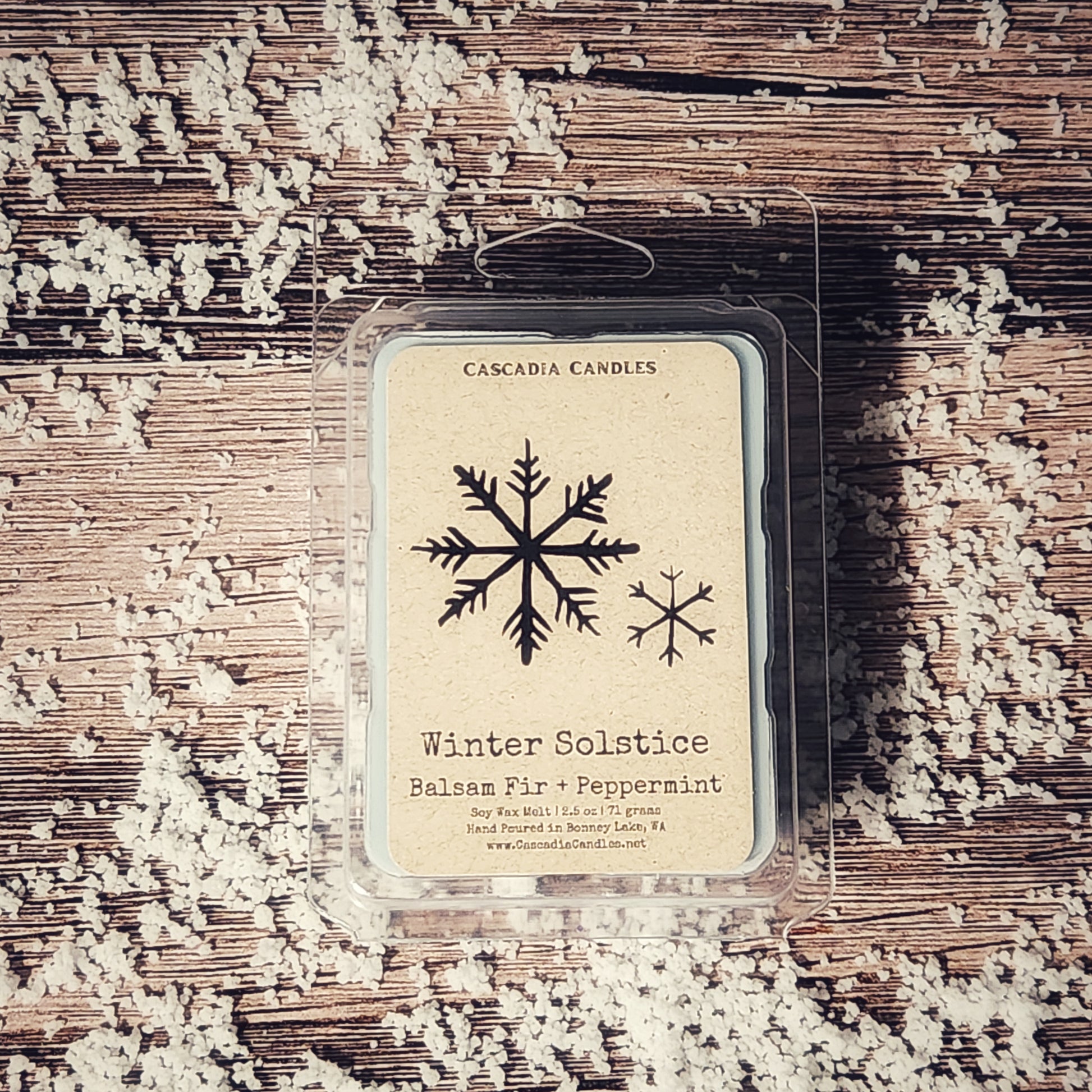 Cascadia Candles winter solstice wax melt package on a textured surface with snowflake design