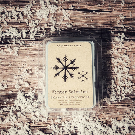 Cascadia Candles winter solstice wax melt package on a textured surface with snowflake design