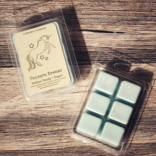 Packaged wax melts with a unicorn design on a wooden surface